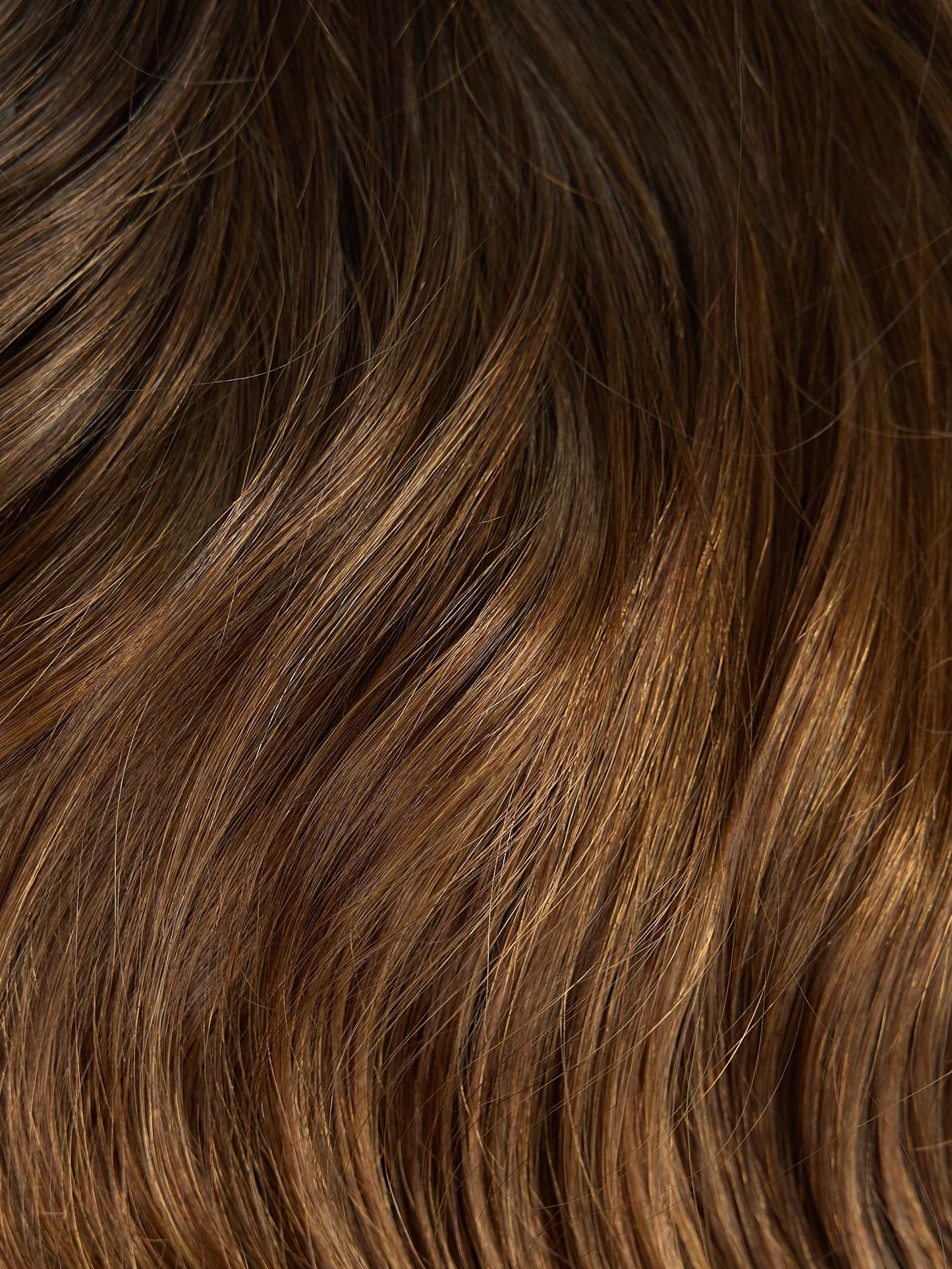 Close-up of brown hair with a wavy texture