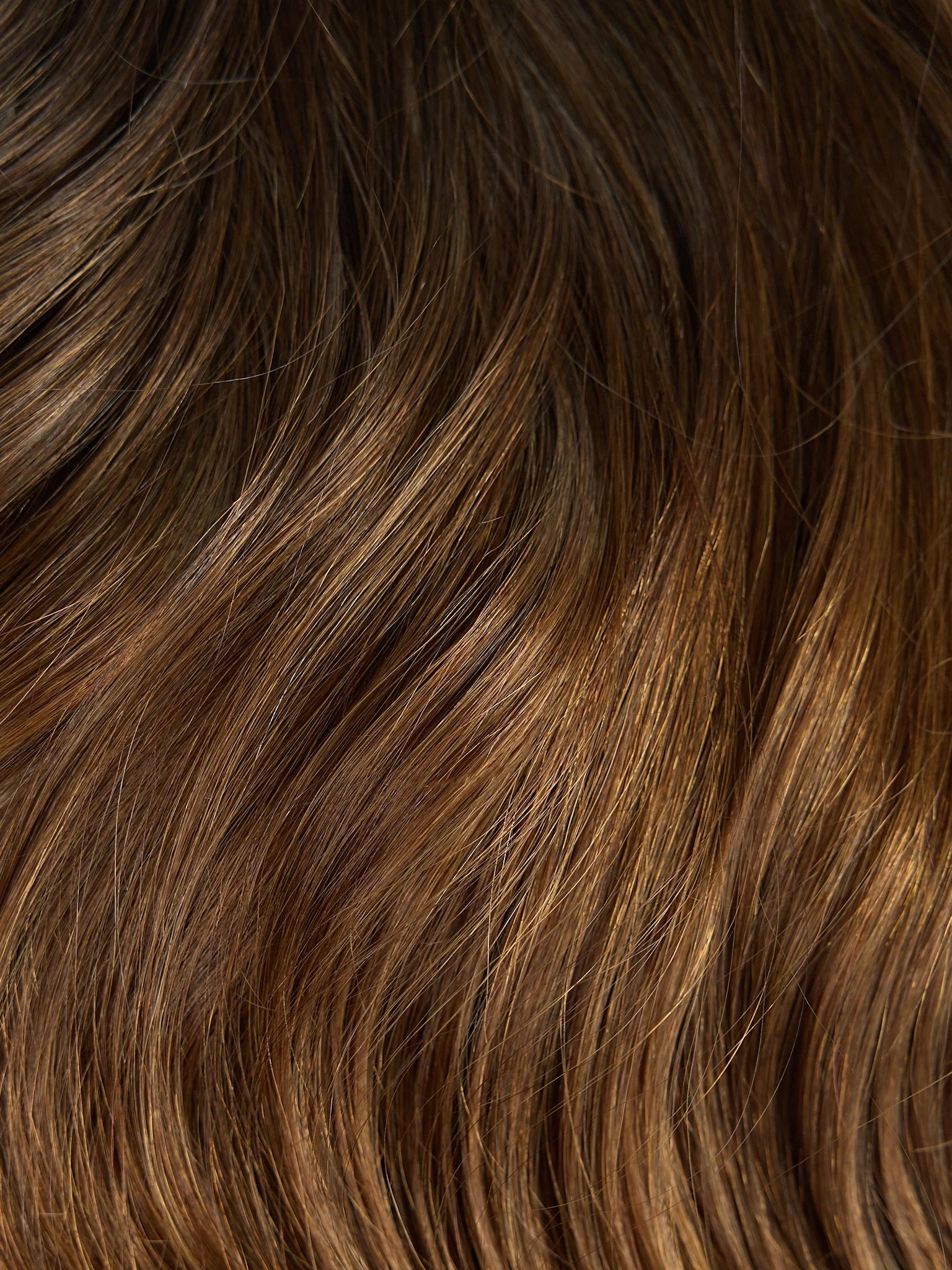 Close-up of brown hair with a wavy texture